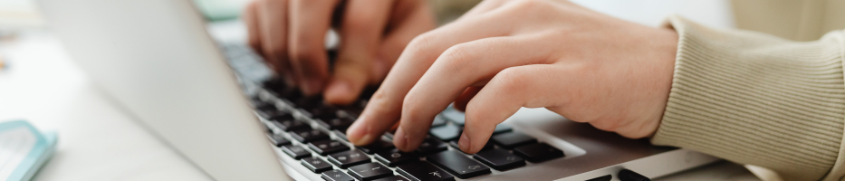 hands typing on a laptop